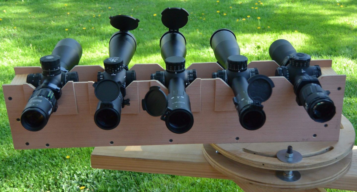 Testing optical performance in a V-block. From right to left: ZC420, Minox ZP5 5-25x56, Minox 5-25x56 LR, Leupold Mark 5HD 5-25x56, Sig Tango6 5-30x56