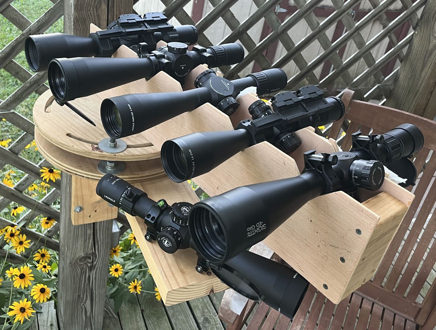 The optical test lineup. From far to near: One of the optical test lineups. From back to front: Sig Tango 6 5-30x56, Leupold Mark5 HD 5-25x56, Leupold Mark4 HD 6-24x52mm, Athlon Ares BTR 4.5-27x50mm,  Sightron S6 5-30x56 FFP IR, below: Leupold Mark4 HD 4.5-18x52mm
