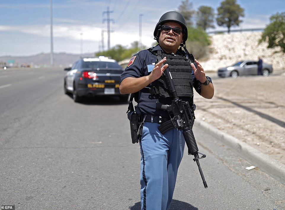 16852798-7317905-Police_stand_at_attention_during_an_active_shooter_at_a_Walmart_-a-74_1564864...jpg