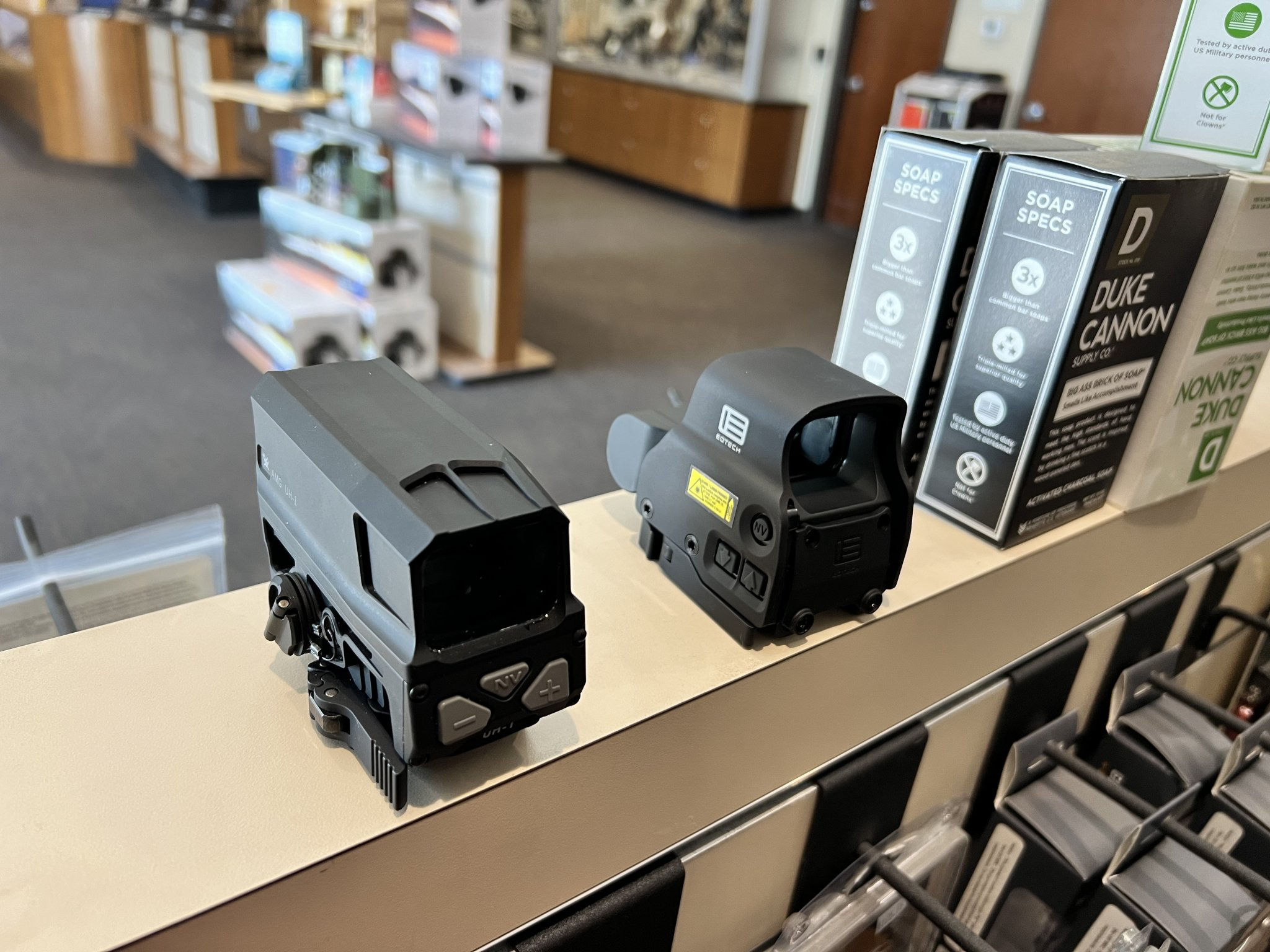 A group of black objects on a shelfDescription automatically generated