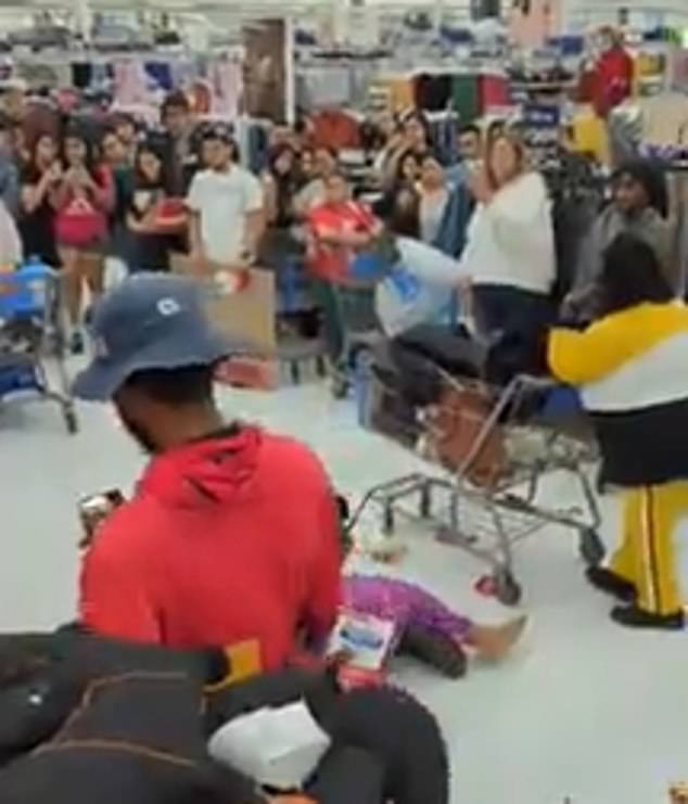 76122813-12588943-Customers_are_seen_crowding_around_the_scene_as_Walmart_employee-m-142_16963...jpg