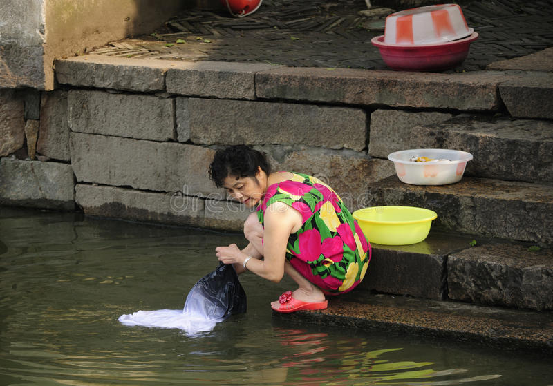 asian-woman-washing-clothes-chinese-laundry-off-stone-steps-water-canals-tongxiang-wuzhen-east...jpg