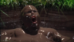 Augustus_in_the_chocolate_river.PNG.png