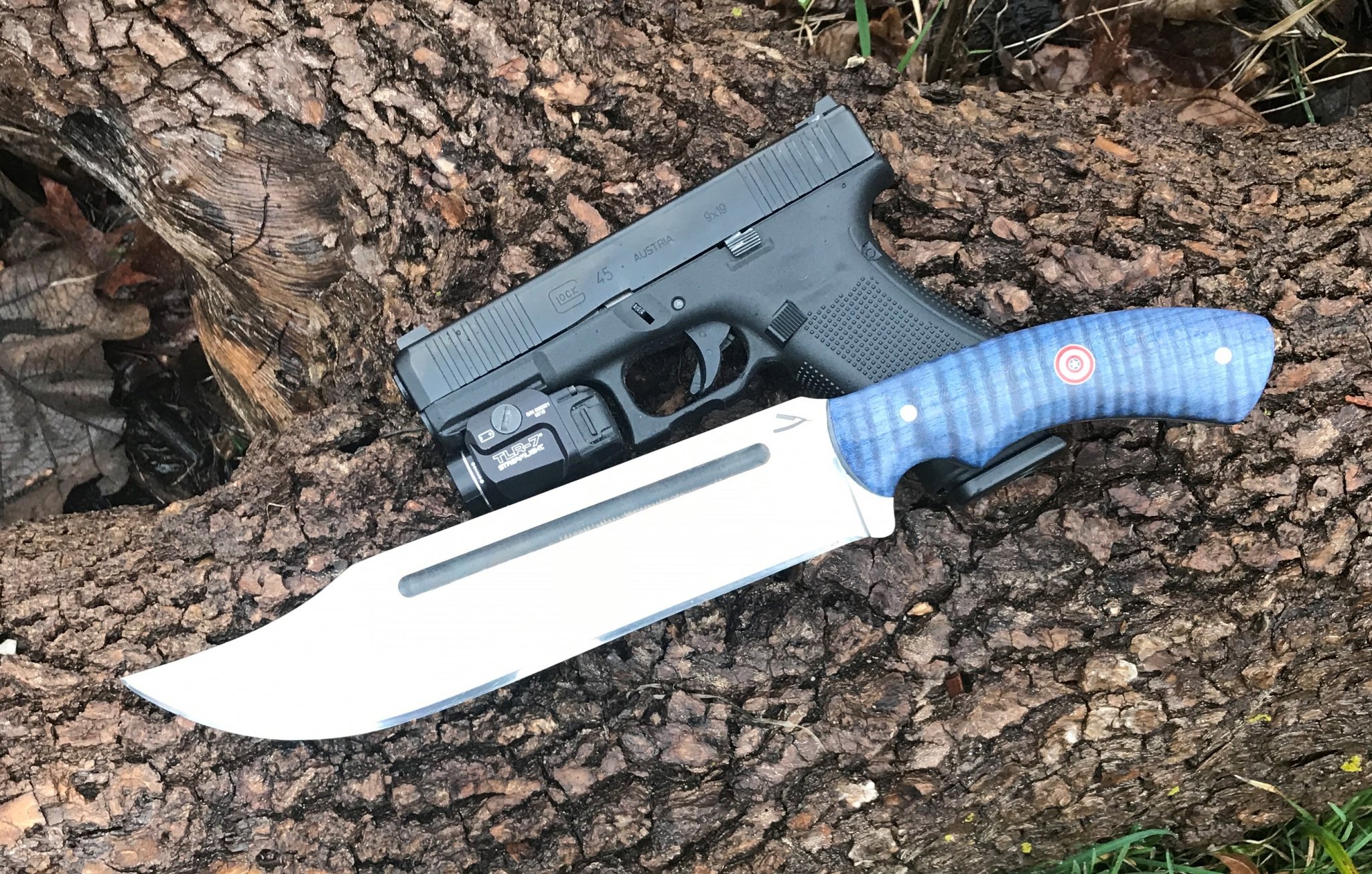 Captain America with Glock 45 on log.JPG