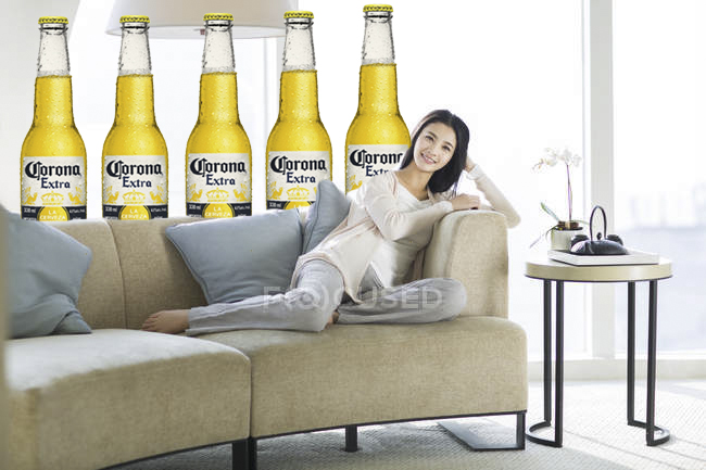 focused_183038382-stock-photo-chinese-woman-sitting-sofa-living.jpg