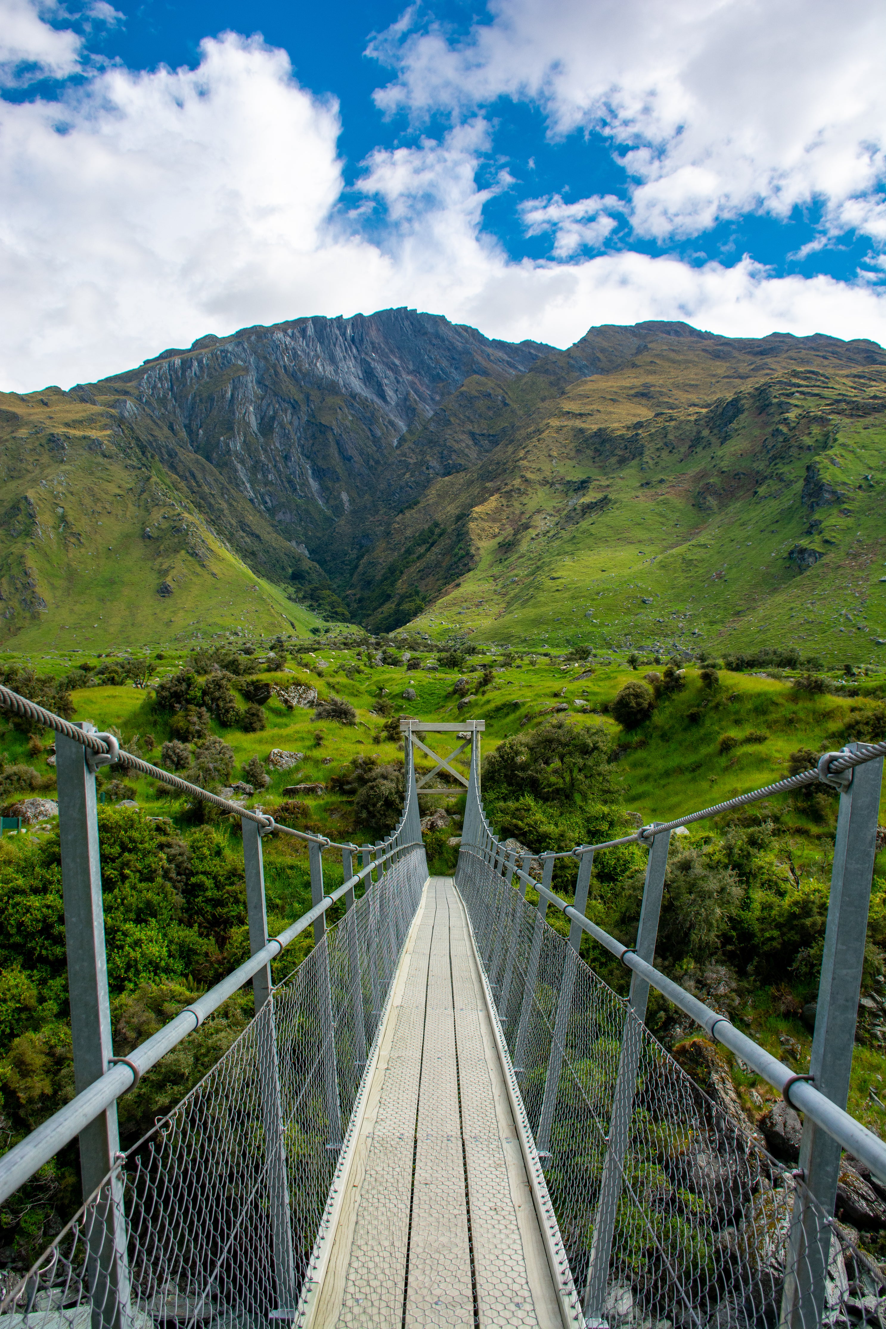 hanging-bridge-over-icelandic-fields-and-mountain.jpg