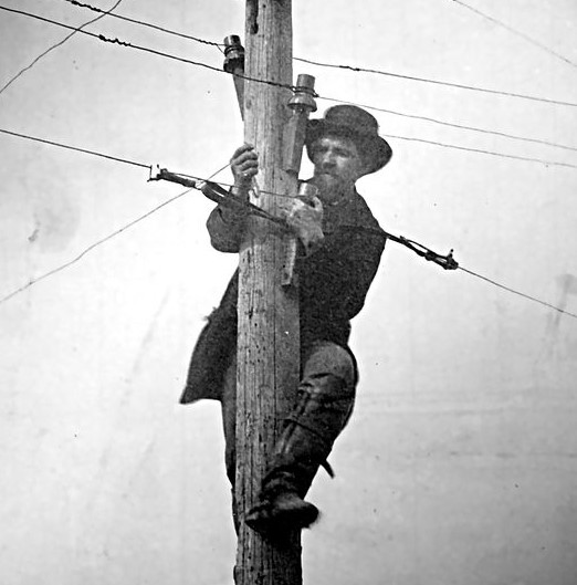 Telegraph-Lineman-on-pole-repairing-slpicing-lines.jpg