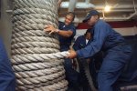 US_Navy_051012-N-6125G-043_Deck_Department_personnel_work_together_while_stowing_the_mooring_lin.jpg