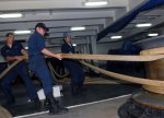 US_Navy_061102-N-9928E-021_Sailors_from_deck_department_heave_mooring_lines_around_capstans_as_t.jpg