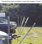 the-parking-signs-outside-a-laser-eye-surgery-center-tired-11153064.png